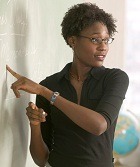 teacher at board, explaining a lesson