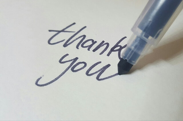 calligraphy pen writing "thank you"