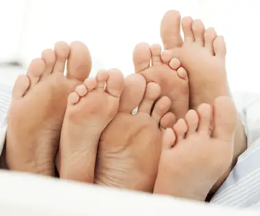 3 pairs of bare feet