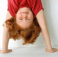 first grader standing on hands, upside down