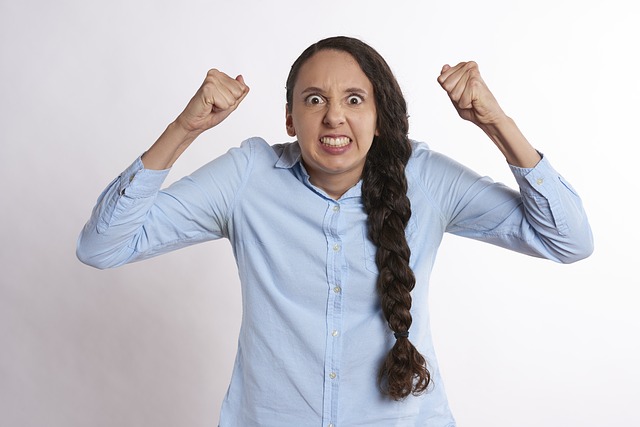 Frustrated young woman, shaking her fists