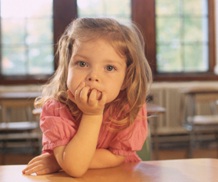 preschool girl leaning on desk