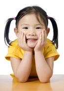 smiling preschool girl with pigtails