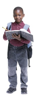 second grade boy writing into a notebook